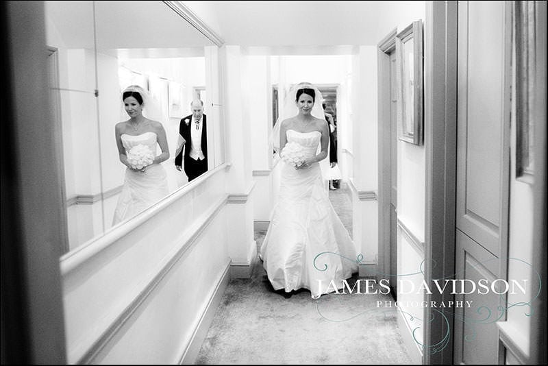 bride walking through stoke park to her wedding