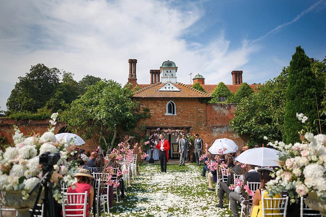 Wedding ceremony outdoors at Woodhall Manor