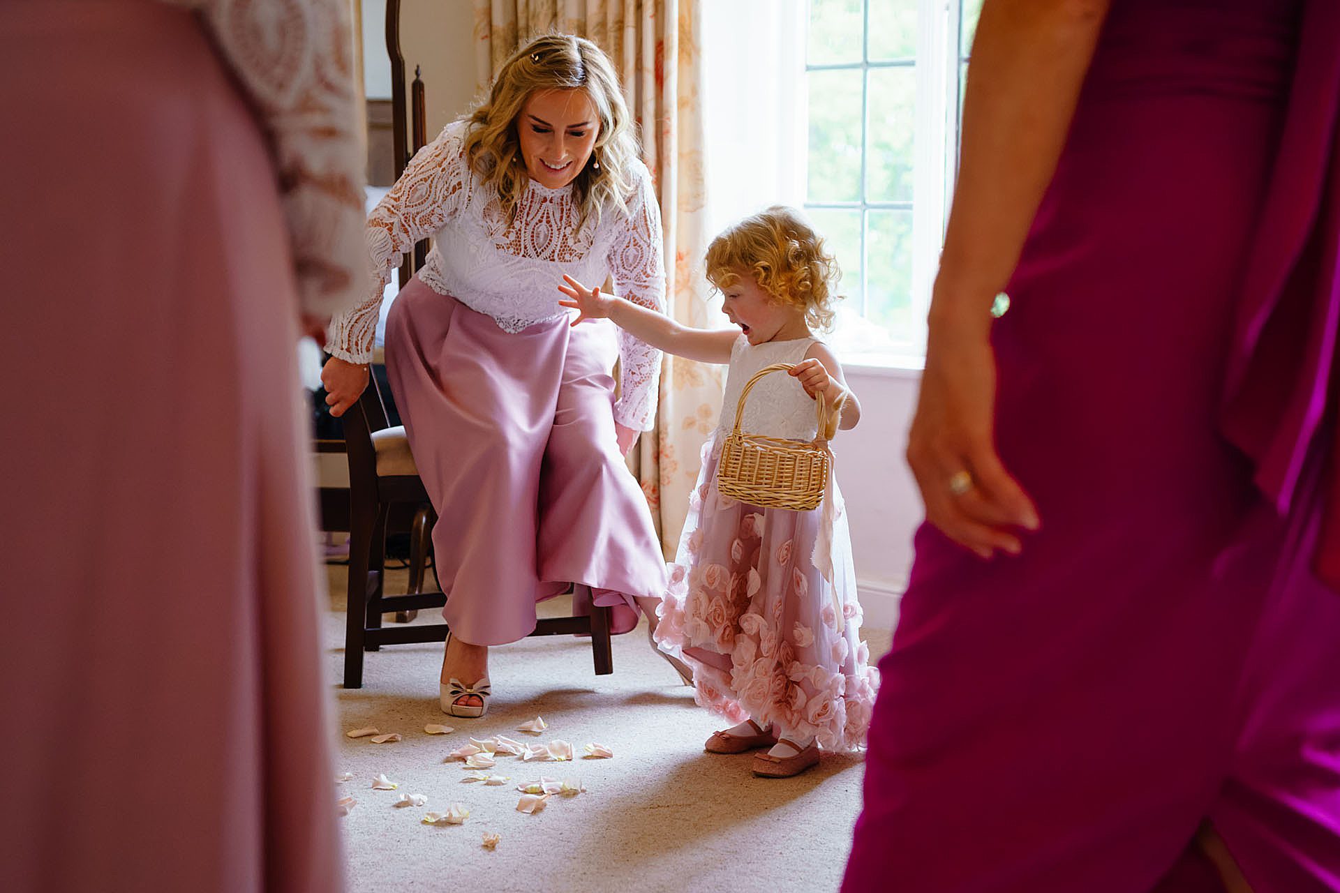 flower girl playing with petals