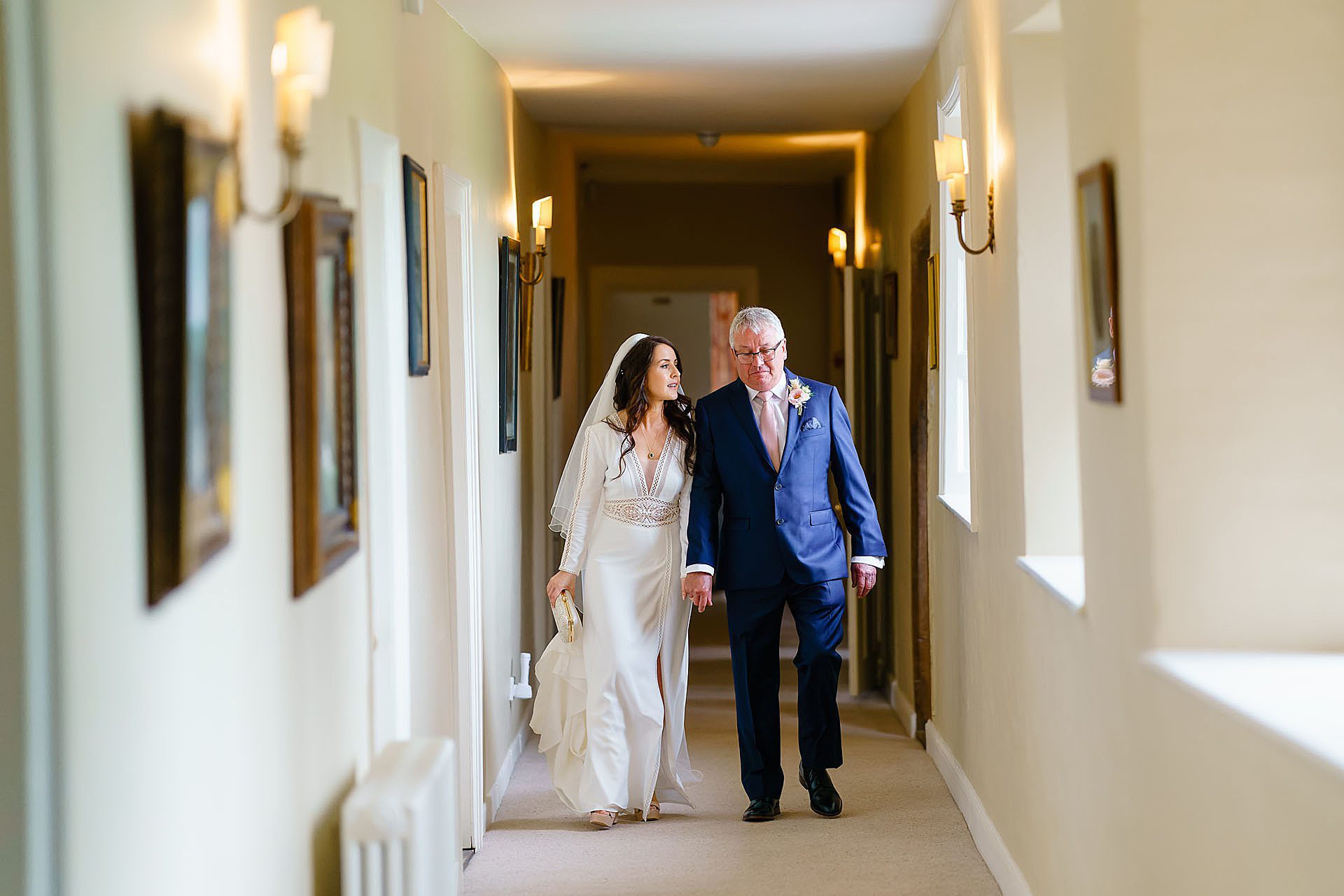 bride walking through the hall with her father