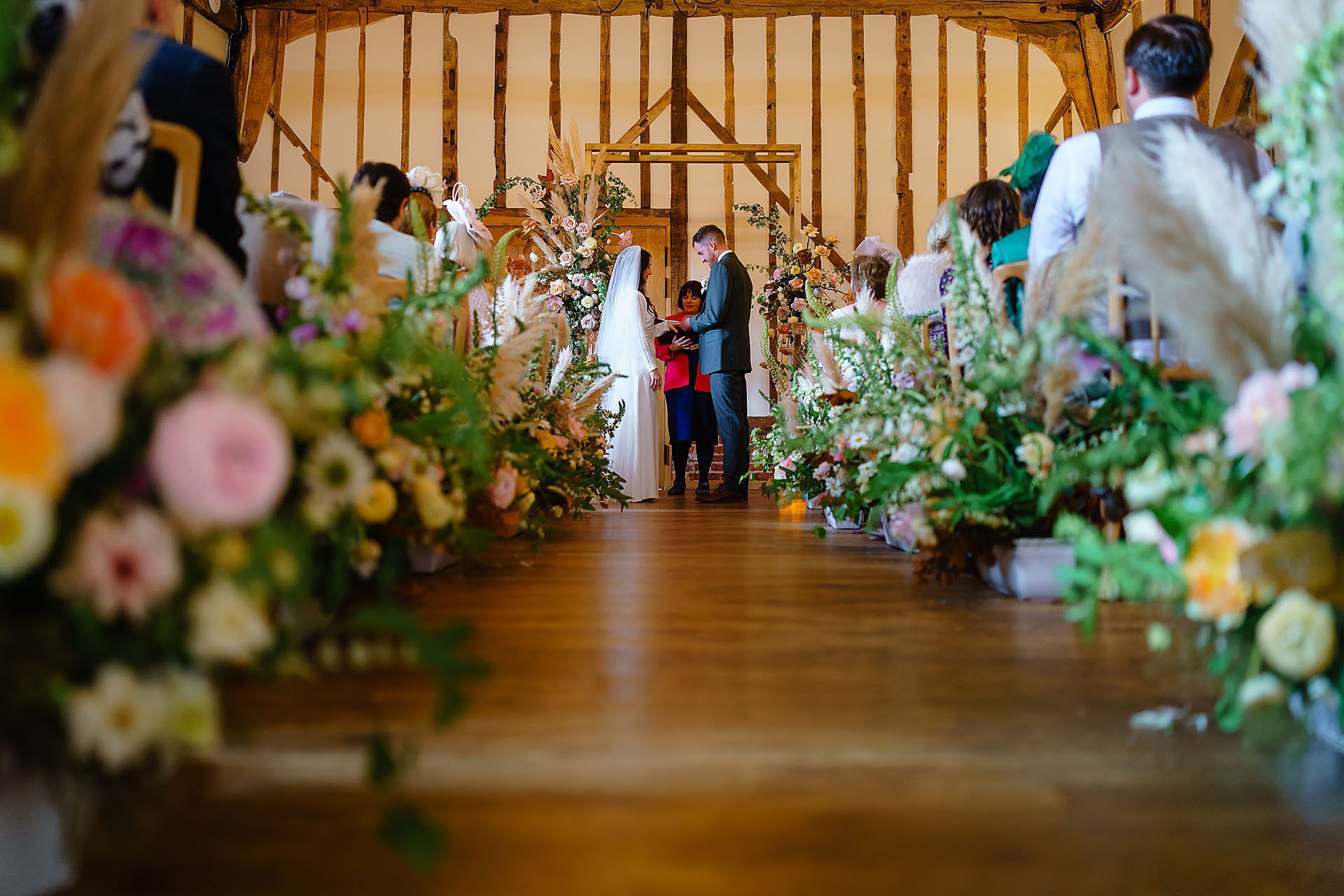exchanging wedding rings at Bruisyard Hall spring wedding