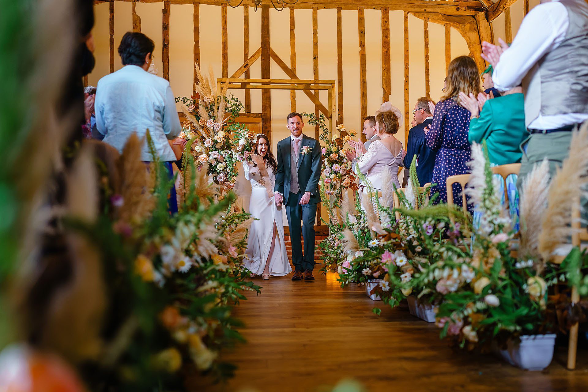 celebrating by walking down the aisle after the wedding ceremony