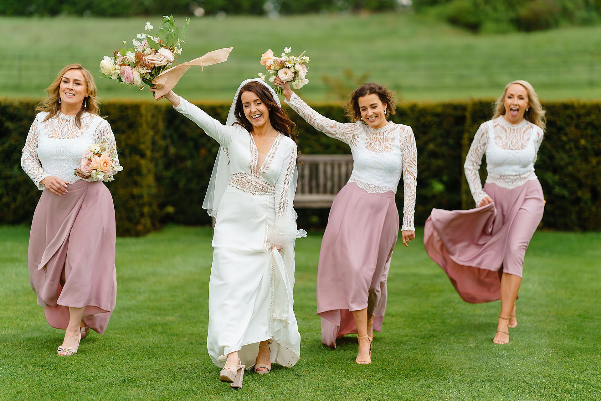 Bridesmaids running at Bruisyard Hall spring wedding