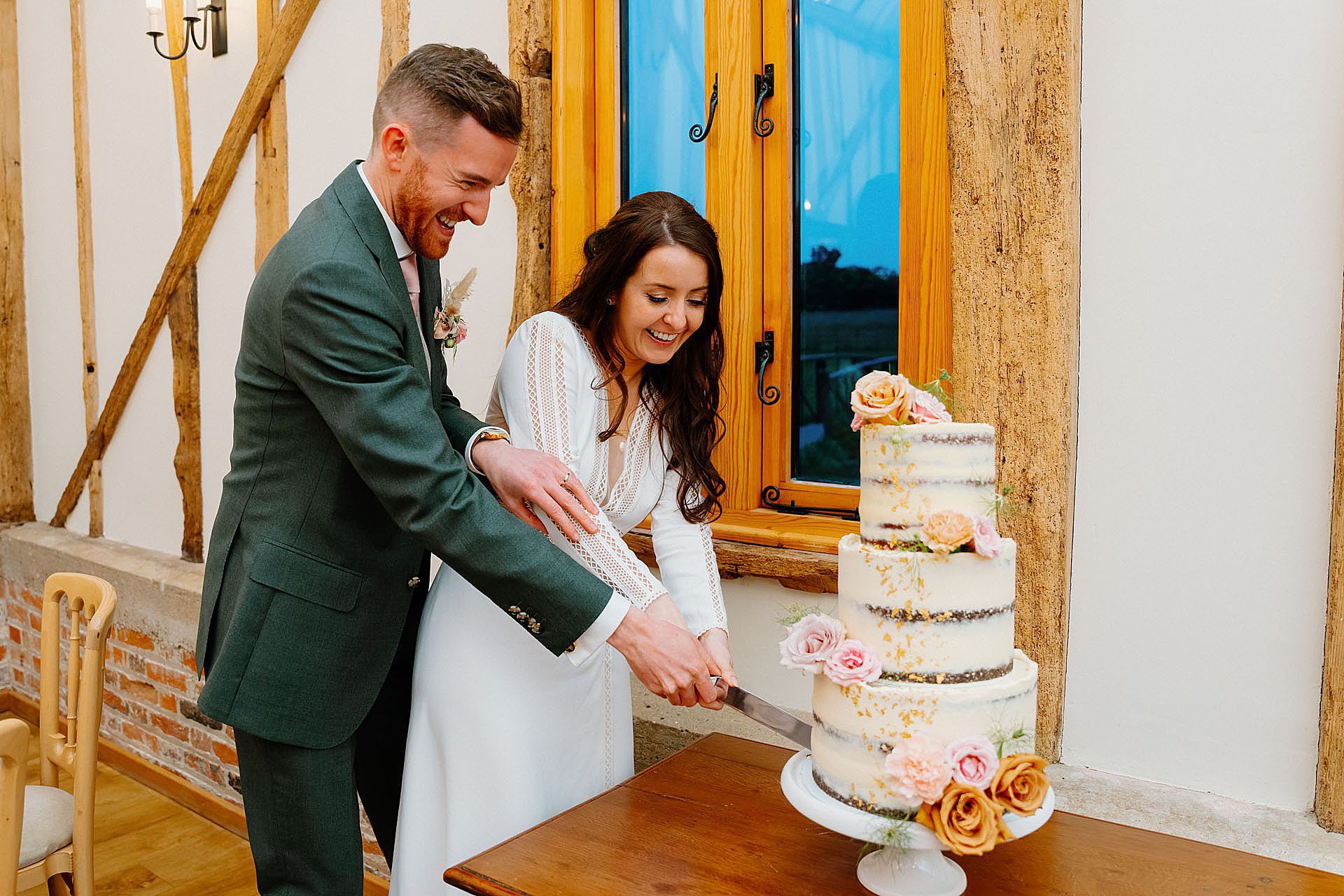 bride and groom cutting the cake