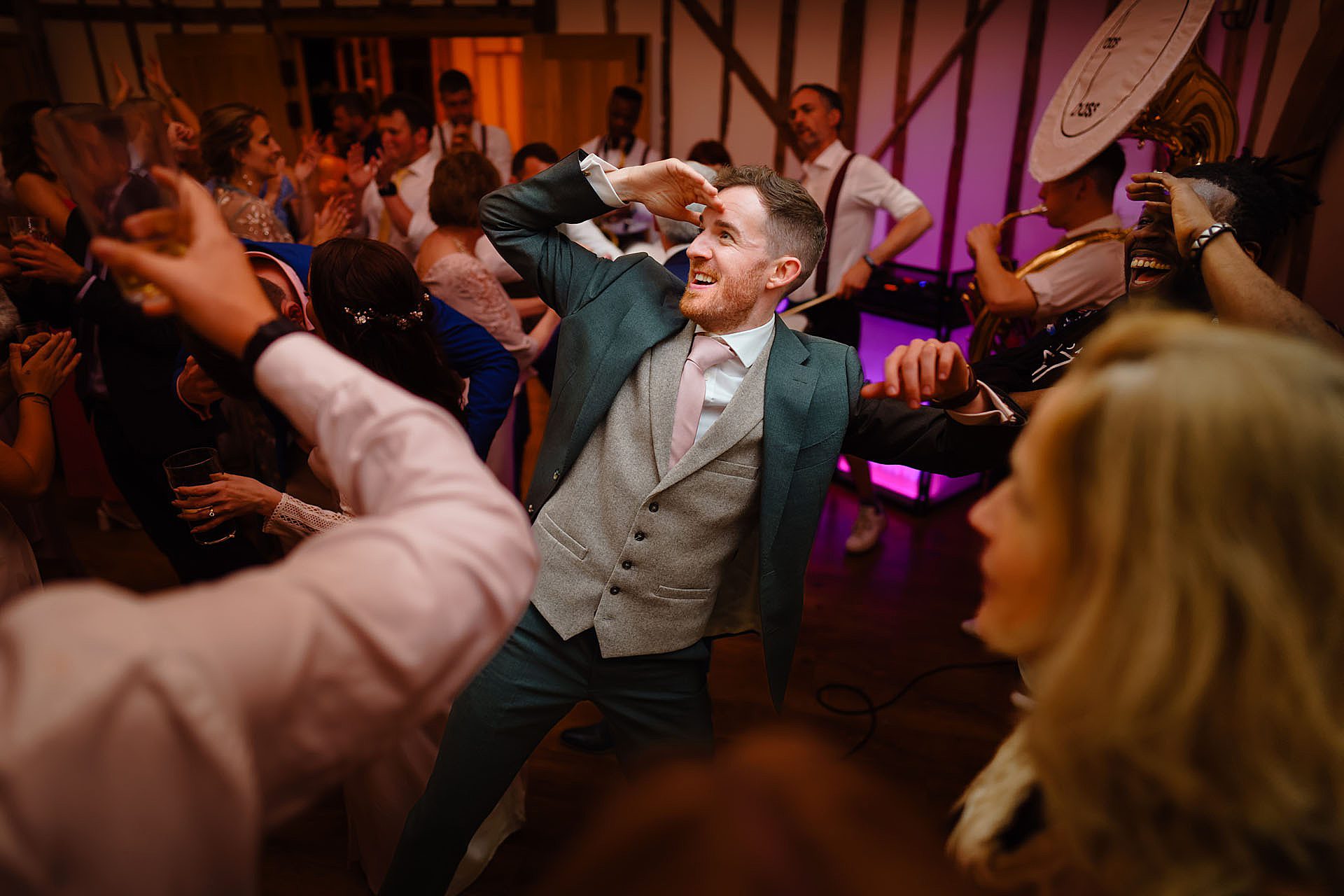 groom dancing in the barn at Bruisyard Hall