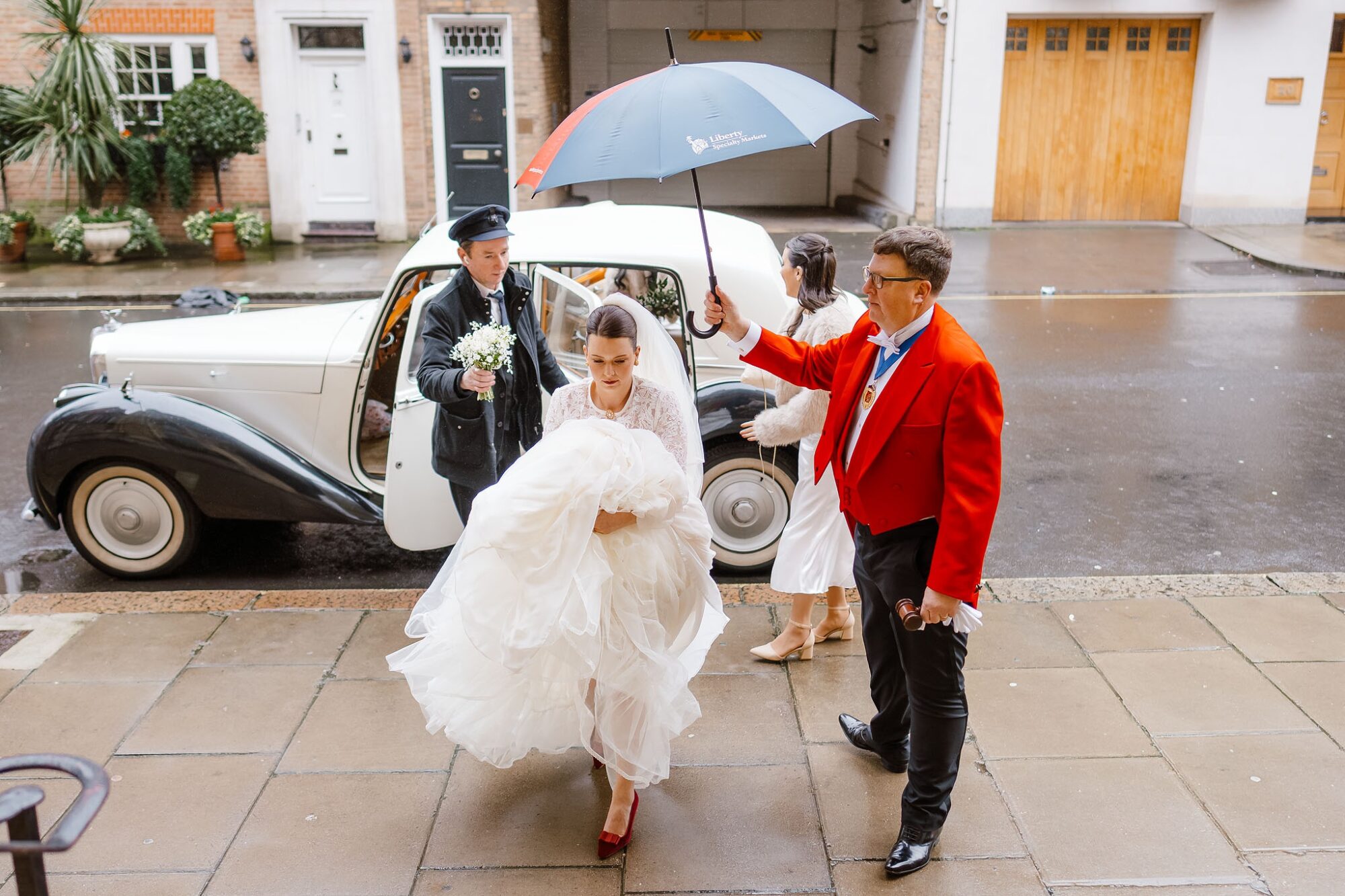 A bride walking into a Farm Street Church winter wedding